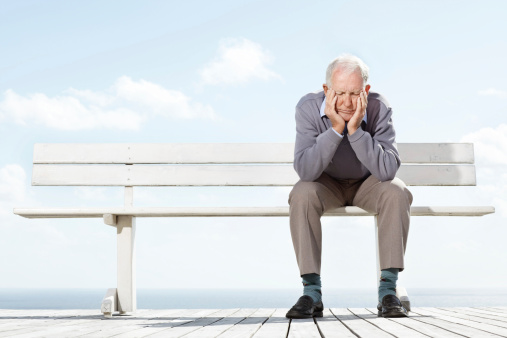 Depressed old man sitting on the bench - Outdoor