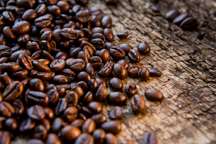 Coffee beans on wood texture background