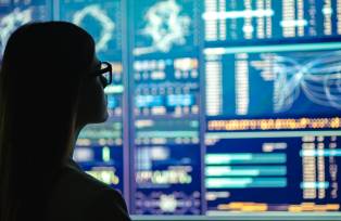 The businesswoman in glasses standing near the display