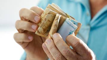 Hands holding Brazilian real notes - Money from Brazil - Notes of Real - Brazil BRL banknote