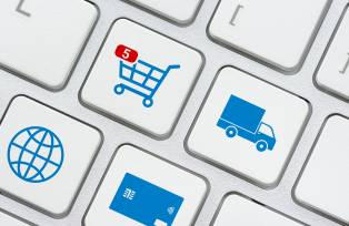 Online shopping / ecommerce and retail sale concept : Shopping cart, delivery van, credit card, world globe logo on a laptop keyboard, depicts customers order things from retailer sites using internet
