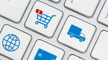 Online shopping / ecommerce and retail sale concept : Shopping cart, delivery van, credit card, world globe logo on a laptop keyboard, depicts customers order things from retailer sites using internet