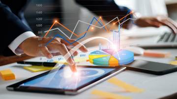 Businessman using tablet and laptop analyzing sales data and economic growth graph chart. Business strategy. Digital marketing. Business innovation technology concept