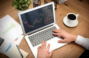 Broker or investor analyzing chart in office