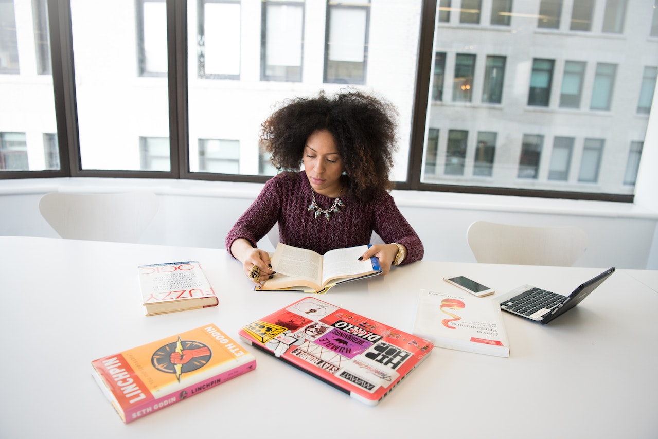 Empreendedora lendo livros e estudando (Foto: Pexels)