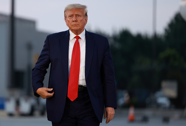 ATLANTA, GEORGIA - AUGUST 24: Former U.S. President Donald Trump arrives to depart at Atlanta Hartsfield-Jackson International Airport after being booked at the Fulton County jail on August 24, 2023 in Atlanta, Georgia. Trump was booked on multiple charges related to an alleged plan to overturn the results of the 2020 presidential election in Georgia. (Photo by Joe Raedle/Getty Images)