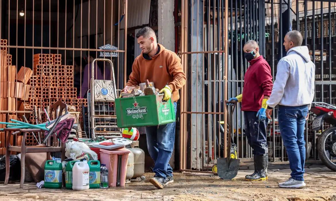 Moradores e voluntários participa, de mutirões de limpezas em residências e empresas gaúchas após as enchentes (Foto: Agência Brasil/Rafa Neddermeyer)