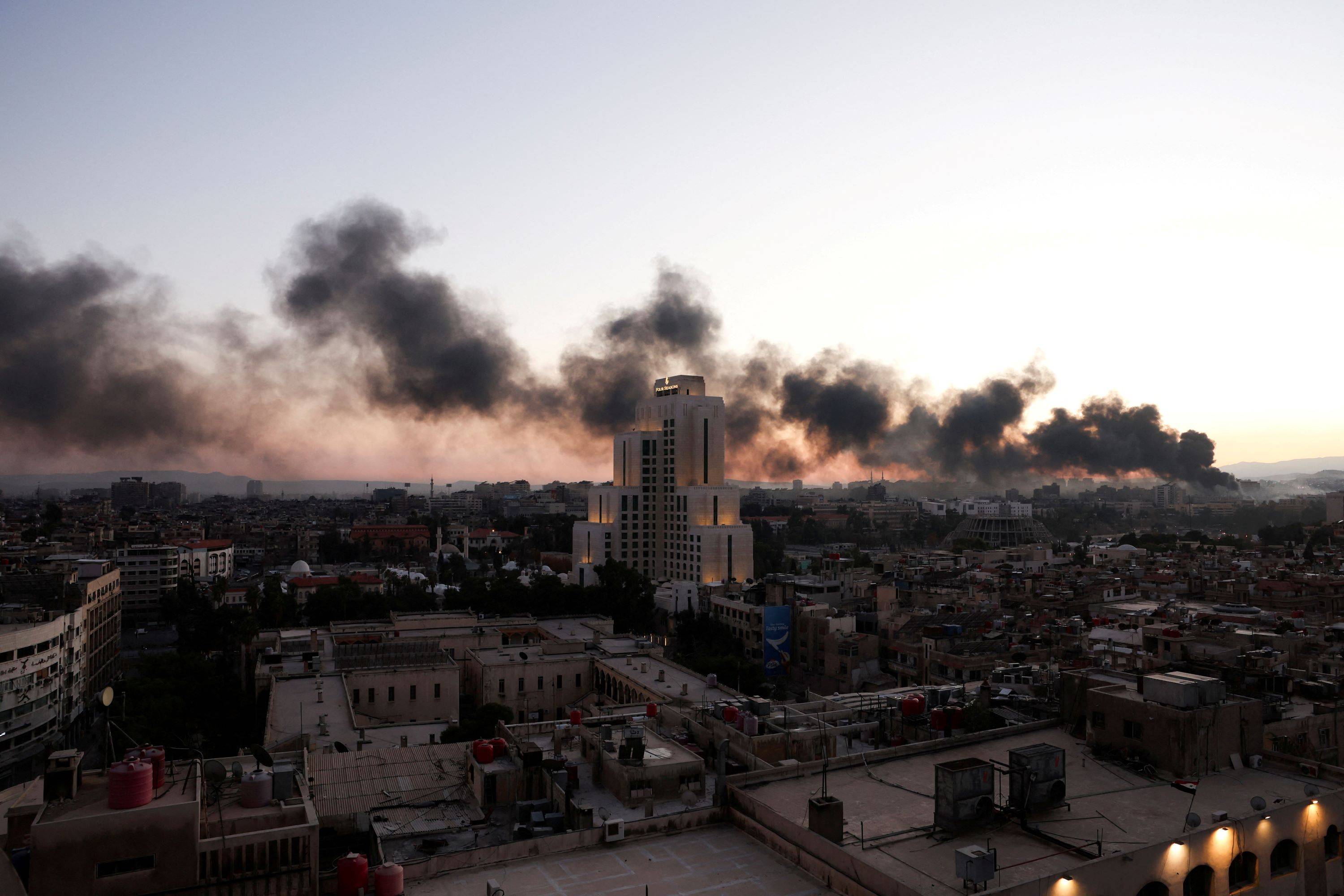 Smoke rises, after Syrian rebels announced that they have ousted Syria's Bashar al-Assad, in Damascus, Syria, December 8, 2024. REUTERS/Mohamed Azakir