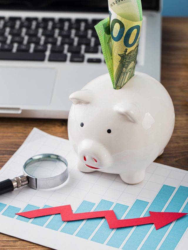 high-angle-office-items-with-piggy-bank-growth-chart
