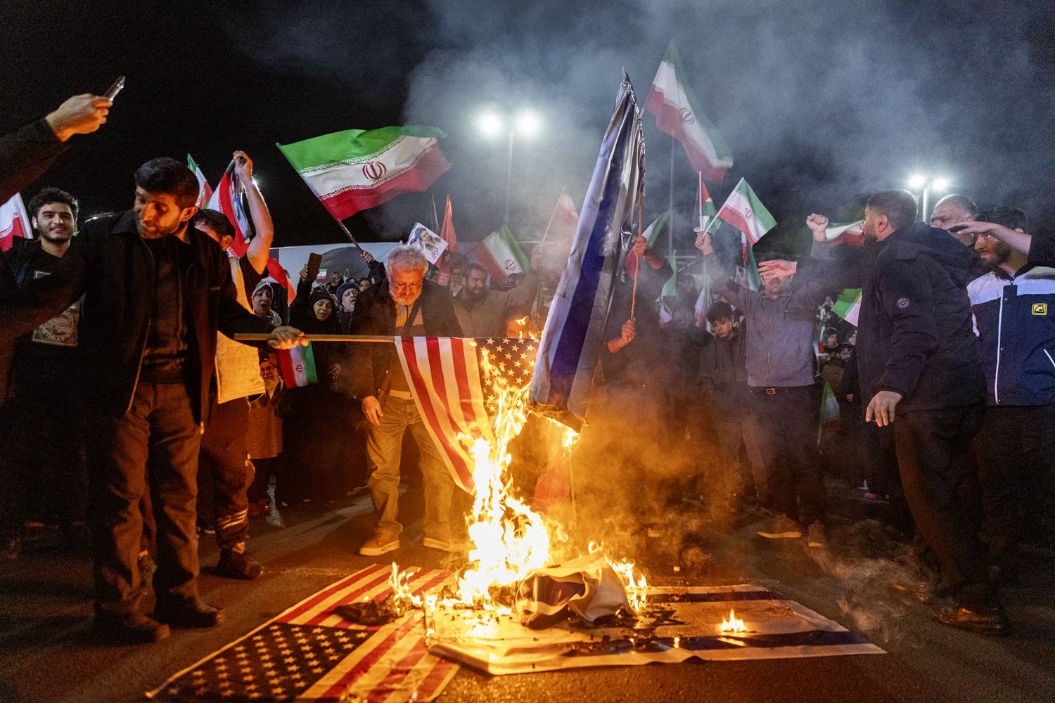 Iranianos queimam bandeiras dos EUA e de Israel em Teerã em 17 de março. Fonte: Getty Images

